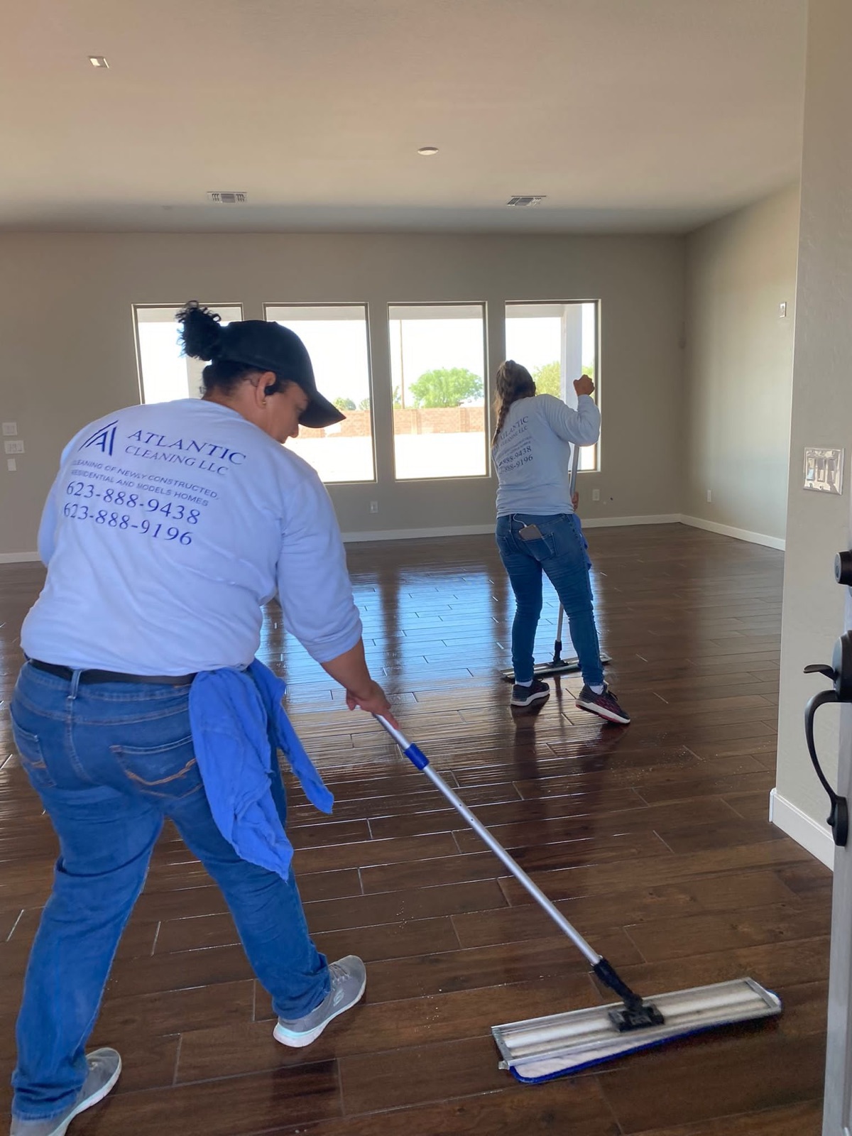Atlantic Cleaning team mopping the floors of a new home